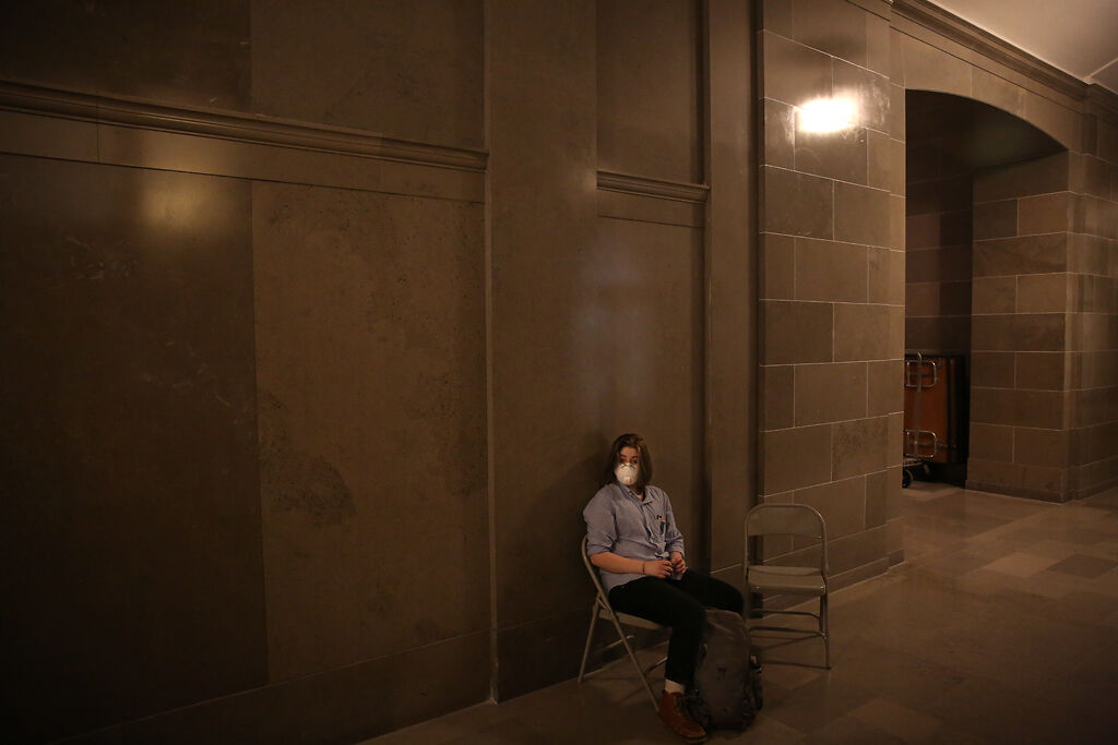 Miles sits outside the Senate Committee Room 1